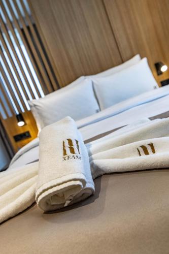 a hotel room with towels on a bed at Hotel Helm in Niš