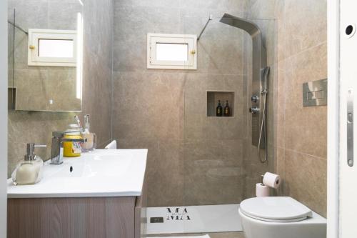 a bathroom with a shower and a sink and a toilet at MEA Suite in Palermo