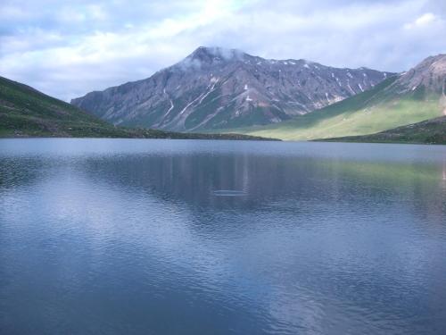 a large body of water with mountains in the background at Golden Hopes Group of Houseboats in Srinagar