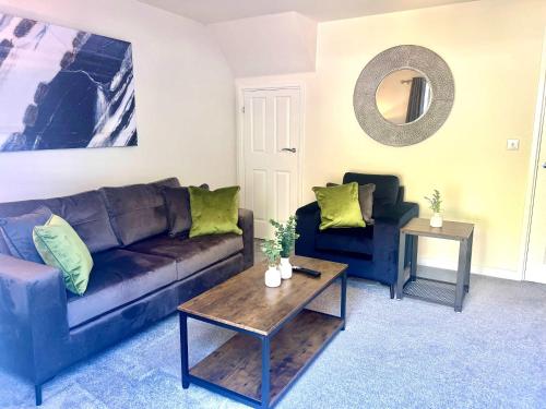 a living room with a couch and a table at Earl House in Coxhoe