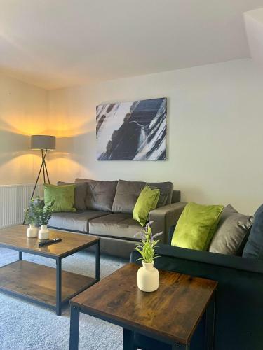 a living room with a couch and a table at Earl House in Coxhoe