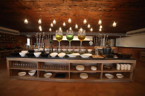 a counter with glasses of wine and bowls at Sayaji Rajkot in Rajkot