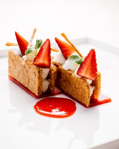 a plate with two slices of bread with fruit on it at Relais Bellaria Hotel & Congressi in Bologna