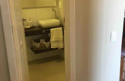 a bathroom with a closet with a sink and towels at Casa da montanha Floripa in Florianópolis