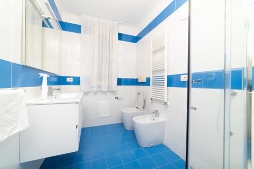 a blue and white bathroom with a toilet and sink at Suites in the Amalfi Coast - GuestHouse with Terrace near Amalfi - Breathtaking View of Ravello in Scala