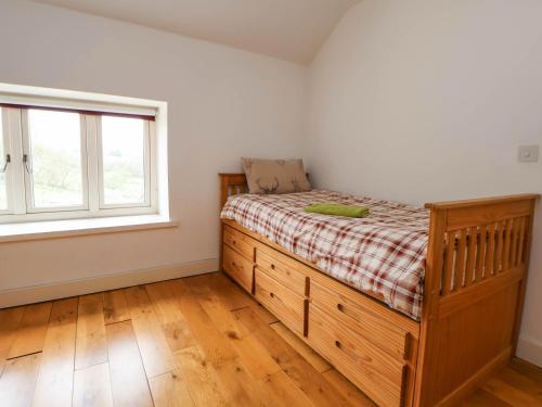 a bedroom with a bed and a window at Sprinks Farm in Leek