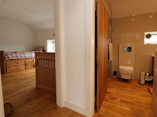 a bathroom with a sink and a toilet in a room at Sprinks Farm in Leek