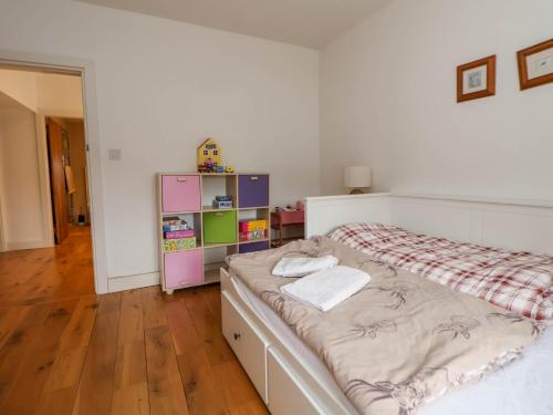 a bedroom with a bed and a book shelf at Sprinks Farm in Leek