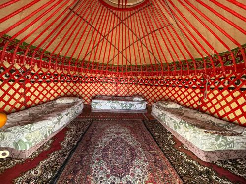 a small room with two beds in a yurt at Yurt camp Chyrak in Tong