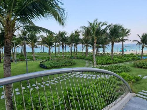 a view from the balcony of a resort with palm trees at Sarang Arena Cam Ranh Seaview Resort condotel in Cam Ranh International Airport