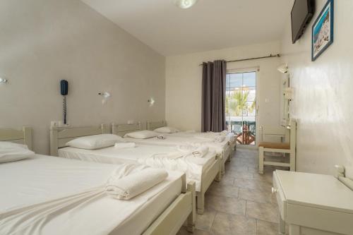 Cama o camas de una habitación en Sunrise Hotel