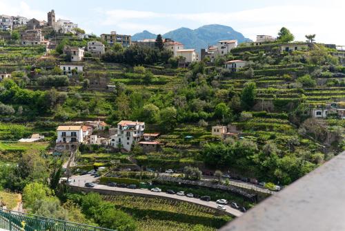 a view of a town on a hill with a road at Suites in the Amalfi Coast - GuestHouse with Terrace near Amalfi - Breathtaking View of Ravello in Scala