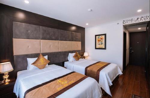 a hotel room with two beds in a room at BẢO MINH RADIANT in Ha Long