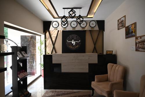 a room with a fireplace with clocks on the wall at Burj Ul Zaki in Islamabad