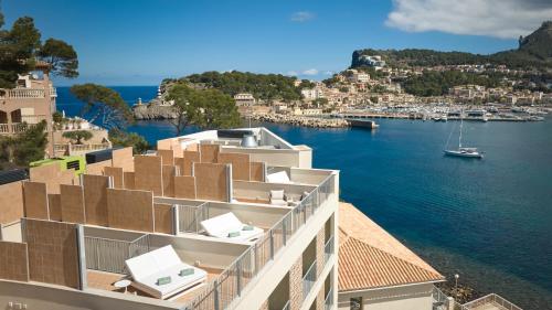 a building with a view of a body of water at Salino Port Soller in Port de Soller