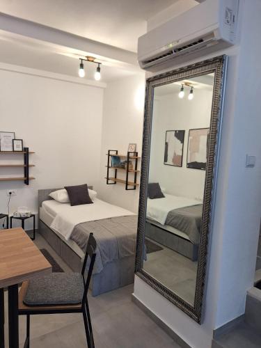a bedroom with a mirror and a bed and a table at Apartments Ankica in Split