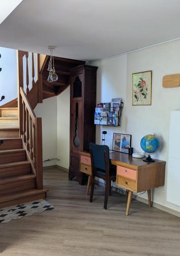 Cette chambre dispose d'un bureau et d'un escalier avec une table et une chaise. dans l'établissement Kerfolie, à Locquémeau