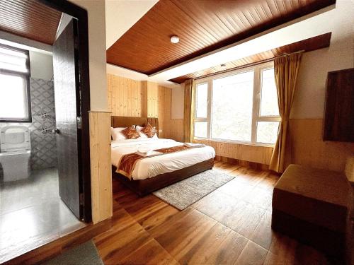 Postel nebo postele na pokoji v ubytování Floret Resort Lachung