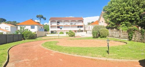 a winding road in front of a house at Plage et centre à 100m avec balcon et parking privé 4 pers in Saint-Brévin-lʼOcéan