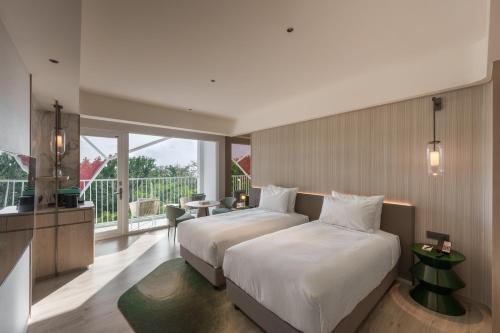 Postel nebo postele na pokoji v ubytování Hotel dua Kenting