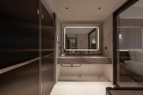 a bathroom with a sink and a mirror at Hotel dua Kenting in Kenting