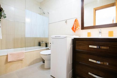 a bathroom with a toilet and a sink and a mirror at La Rosa in Gran Tarajal