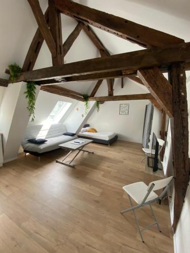 an attic room with wooden floors and wooden beams at La Champenoise La Tannerie in Troyes