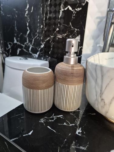 a bathroom with aige soap dispenser on a counter at Villa Tsukino Usagi in Ko Phangan