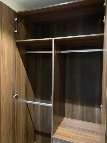 a closet with wooden walls and wooden shelves at Supreme Apartment & Residence in Igbogila