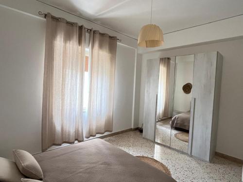 a bedroom with a mirror in front of a bed at Dolce Sicily a 1km dal centro in Palermo
