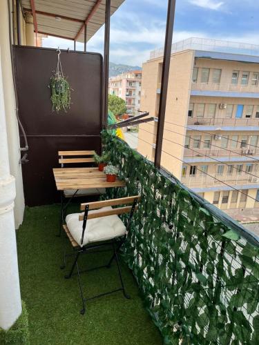 a balcony with a table and chairs on a building at Dolce Sicily a 1km dal centro in Palermo