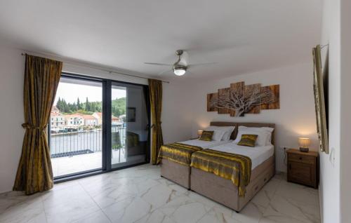 a bedroom with a bed and a large window at Villa Juma by Villas Guide in Blace