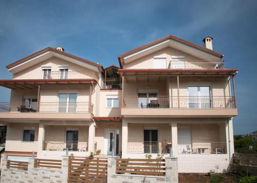 a large building with balconies and a blue sky at Luxury Maisonette in Ioannina