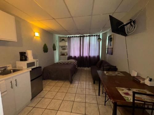 a kitchen and a living room with a bed and a table at Verdemar Apts in San Juan
