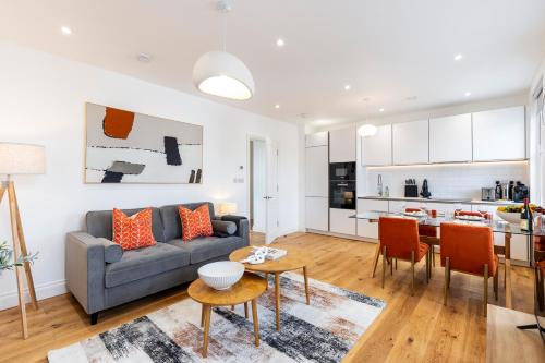 a living room with a couch and a table at The Fulham Residences in London