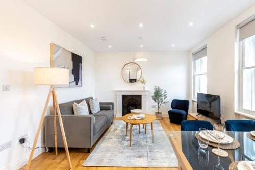 a living room with a couch and a table at The Fulham Residences in London