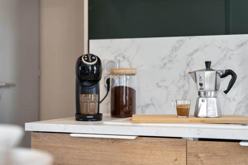 a coffee maker on a counter with a cup of coffee at Holiday home La Casetta in Kinrooi