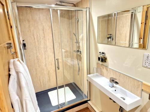 a bathroom with a shower and a sink at Borlum House in Thurso