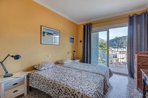 Un dormitorio con una cama y una ventana con vistas. en Neptuno 1 Simple Apartment in Port de Soller, en Sóller