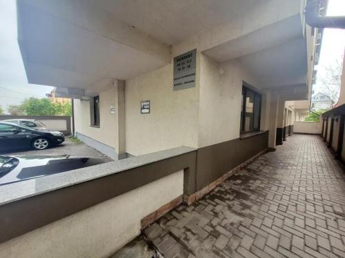 a building with a car parked in a parking lot at Morii Lake Studio in Bucharest