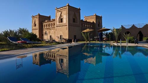a building with a swimming pool in front of a building at kasba Harmony in Oulad Saïd