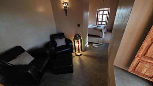 a living room with two chairs and a fire hydrant at kasba Harmony in Oulad Saïd