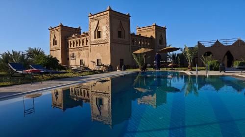 a swimming pool in front of a building at kasba Harmony in Oulad Saïd