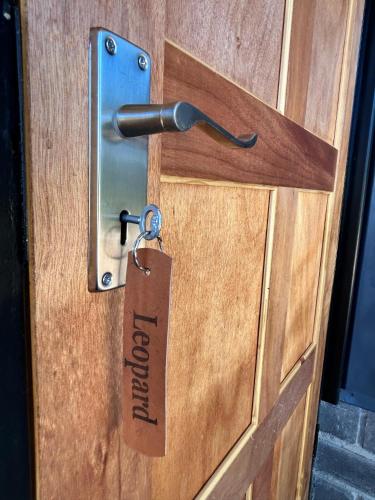 a door with a lock and a tag on it at Northern Rock Campsites in Otjiwarongo