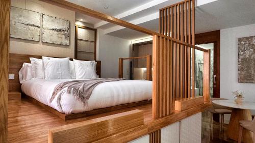 a bedroom with a large bed and a table at Corral del Carbón GG Luxury Hotel Boutique in Granada
