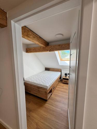 a bedroom with a bed and a vaulted ceiling at Dom Odpoczynku Mazury in Sorkwity