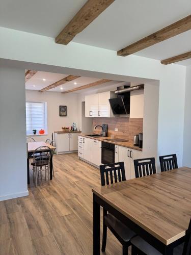 a kitchen and dining room with a table and chairs at Dom Odpoczynku Mazury in Sorkwity
