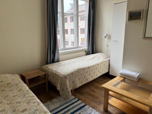 a small room with two beds and a window at Jämsän Gasthaus in Jämsä