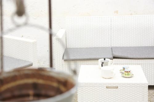 a table with a cup and a plate on it at Corte Micetti 1- Centro storico in Gallipoli