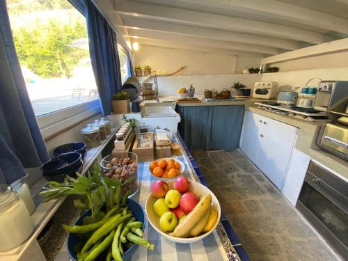 a kitchen with a bowl of fruit on a counter at Valle dei Mulini B&B in Marciana